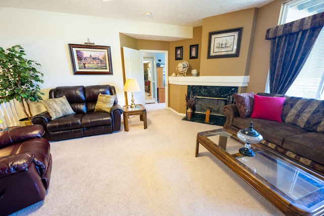 living room featuring plenty of natural light, carpet floors, a textured ceiling, and a fireplace