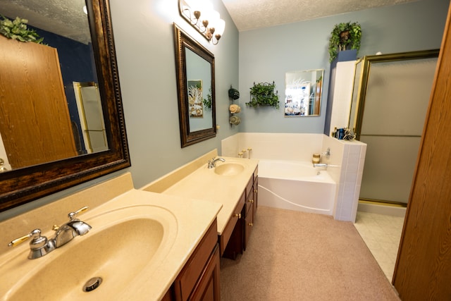 bathroom with plus walk in shower, vanity, and a textured ceiling