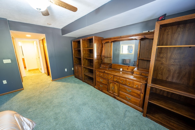 carpeted living room with ceiling fan