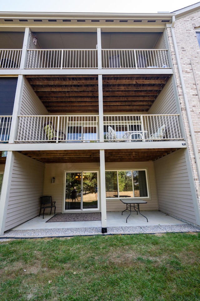 back of property featuring a patio and a balcony