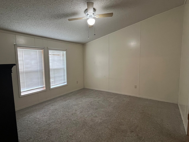 carpeted spare room with ceiling fan and a textured ceiling