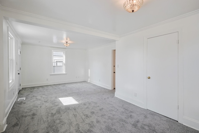 carpeted spare room featuring ornamental molding