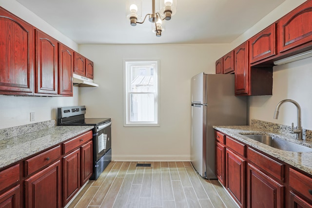 kitchen featuring light hardwood / wood-style floors, light stone countertops, black electric range, an inviting chandelier, and sink