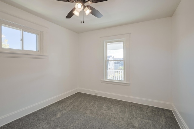 carpeted empty room featuring ceiling fan and plenty of natural light