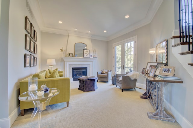 living room with carpet floors, ornamental molding, and french doors