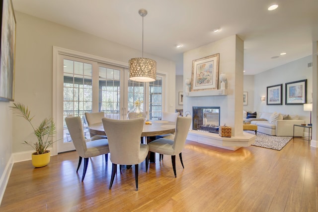 dining space featuring a fireplace and hardwood / wood-style floors