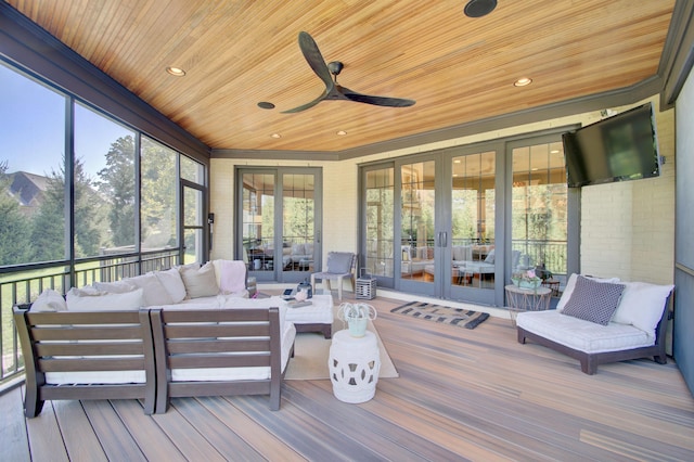 sunroom / solarium with ceiling fan, a healthy amount of sunlight, french doors, and wood ceiling