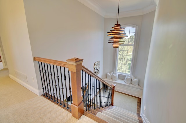 stairway featuring ornamental molding