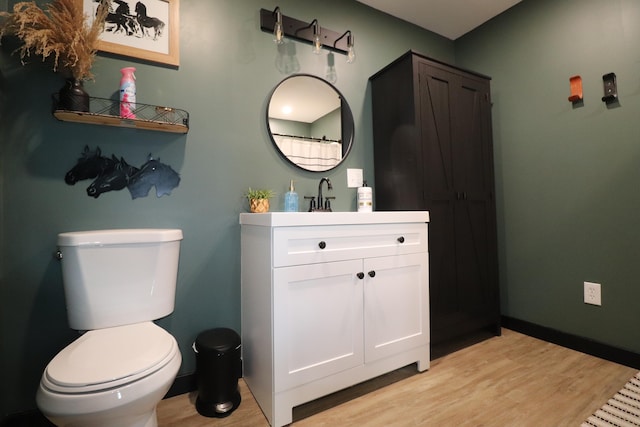 bathroom with vanity, hardwood / wood-style floors, and toilet