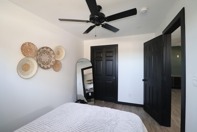 bedroom featuring ceiling fan and dark wood-type flooring