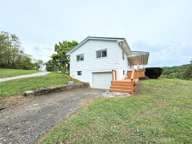 view of home's exterior featuring a garage and a lawn