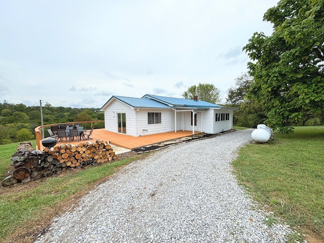 view of front of property with a deck and a front yard