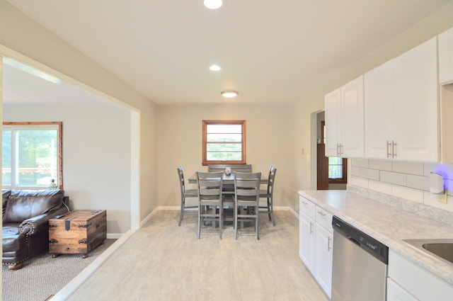 kitchen featuring white cabinetry, tasteful backsplash, and stainless steel dishwasher