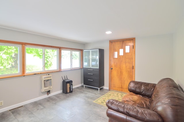 living room featuring heating unit and a wealth of natural light