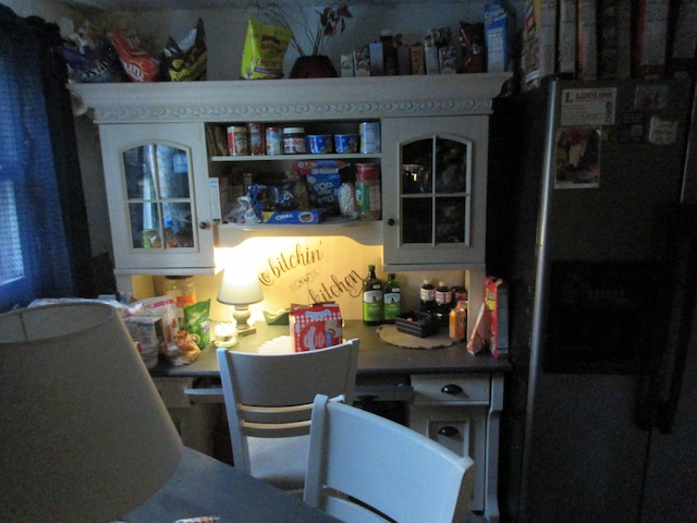 interior space featuring stainless steel refrigerator with ice dispenser