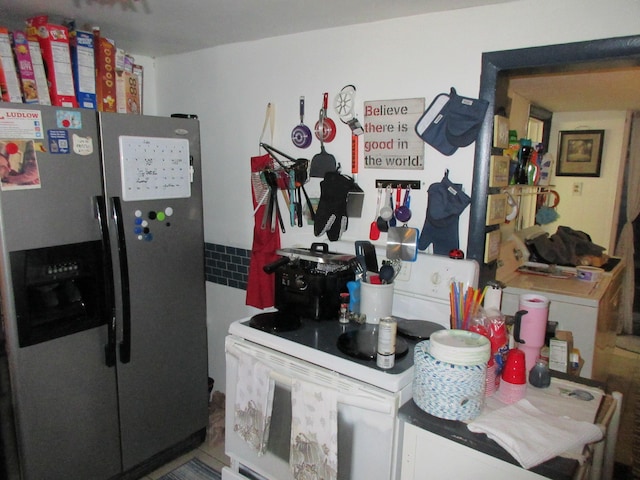 kitchen featuring stainless steel refrigerator with ice dispenser and white range with electric stovetop