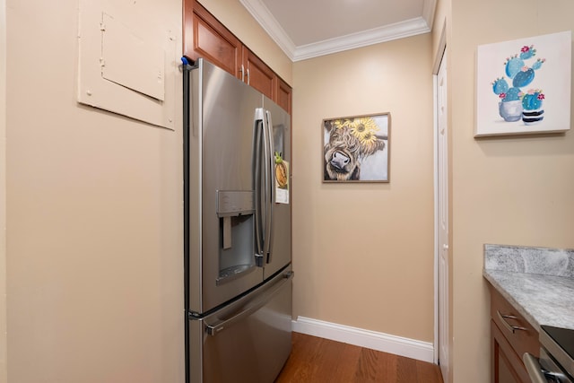 kitchen featuring ornamental molding, dark hardwood / wood-style flooring, and stainless steel appliances