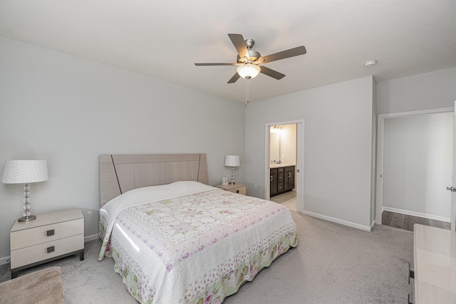 carpeted bedroom with ceiling fan and connected bathroom