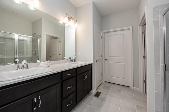 bathroom featuring vanity, tile patterned floors, and a shower with door