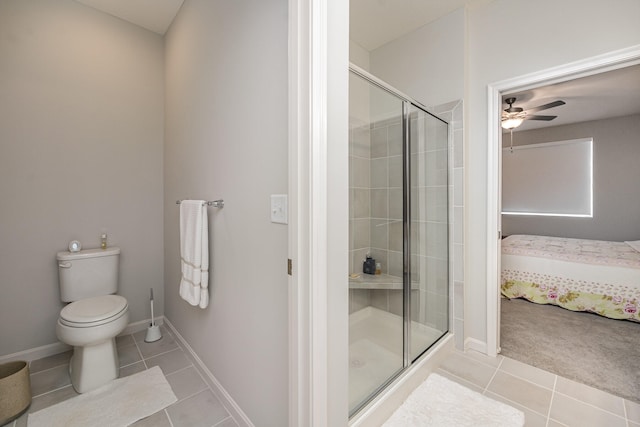 bathroom featuring tile patterned flooring, ceiling fan, an enclosed shower, and toilet