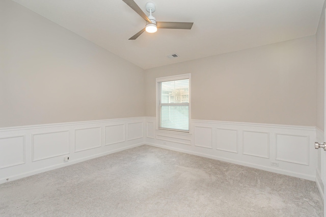 carpeted empty room featuring lofted ceiling and ceiling fan