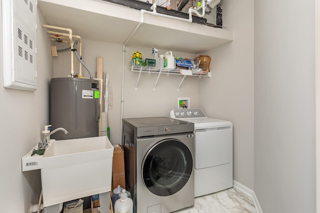 clothes washing area featuring sink, washing machine and clothes dryer, and electric water heater