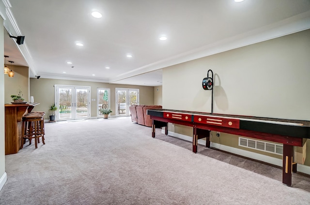 recreation room with french doors, light colored carpet, and ornamental molding