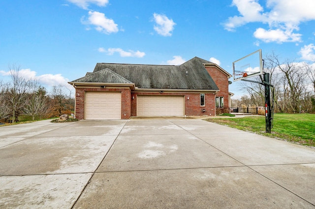 view of side of home featuring a lawn and a garage