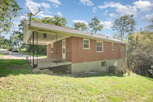 exterior space with central AC and a yard