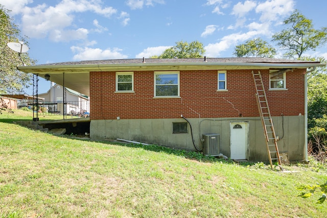 back of property featuring a lawn, a deck, and central air condition unit