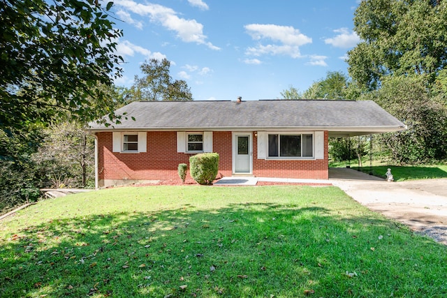 ranch-style home with a front yard and a carport