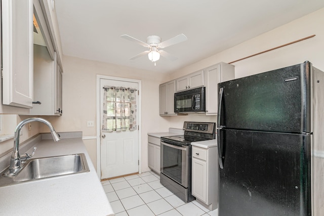 kitchen with light tile patterned flooring, white cabinetry, black appliances, ceiling fan, and sink