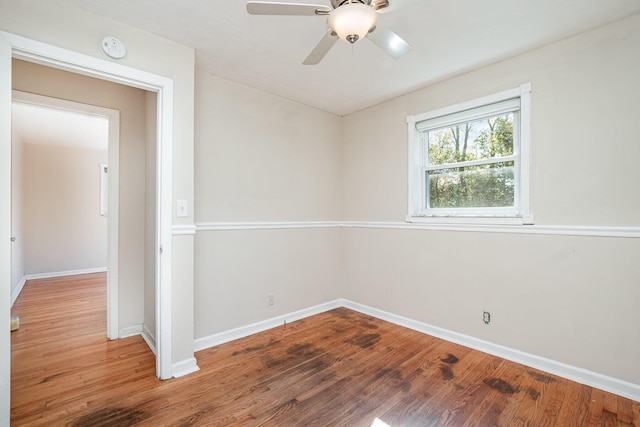 unfurnished room with ceiling fan and hardwood / wood-style flooring