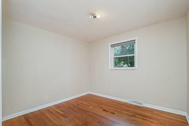 spare room featuring wood-type flooring