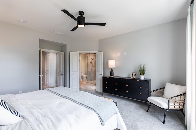 carpeted bedroom featuring ceiling fan and ensuite bathroom