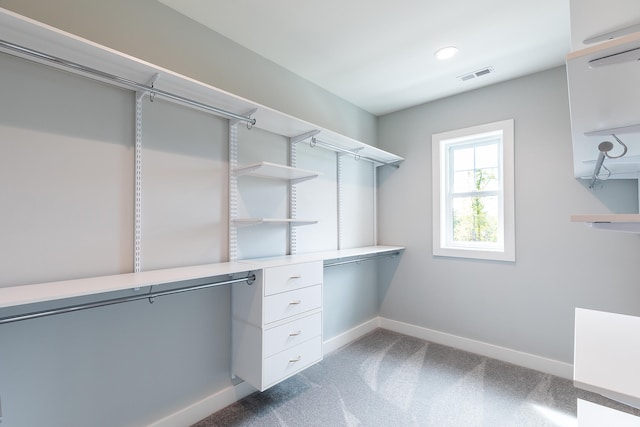 spacious closet featuring dark carpet