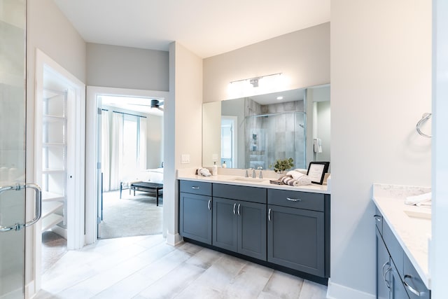 bathroom featuring ceiling fan, vanity, and a shower with door