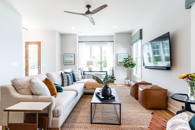 living room with light hardwood / wood-style floors and ceiling fan