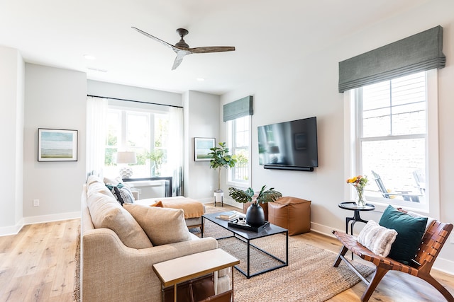 living room with light hardwood / wood-style floors and ceiling fan