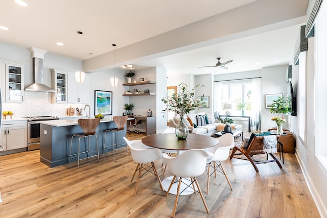 dining room featuring light wood-type flooring and ceiling fan