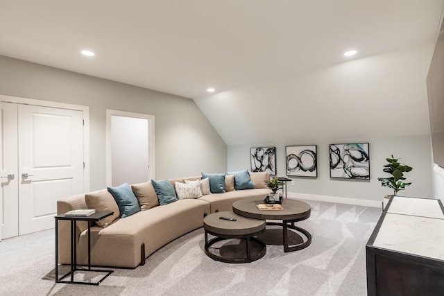 carpeted living room with lofted ceiling