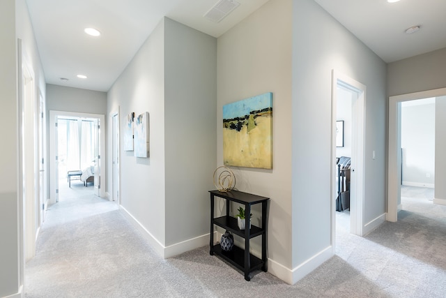 hallway with light colored carpet