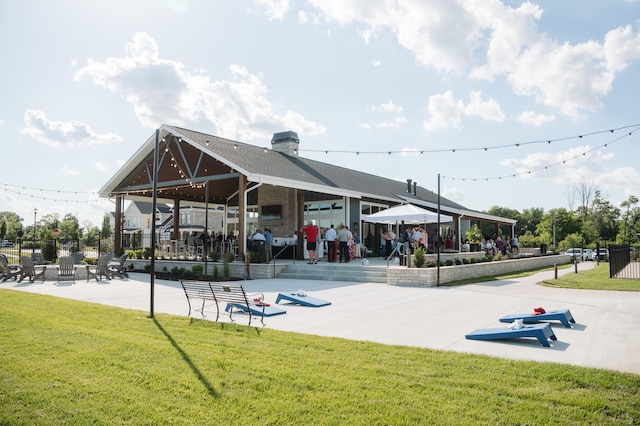 view of community with a lawn and a patio area