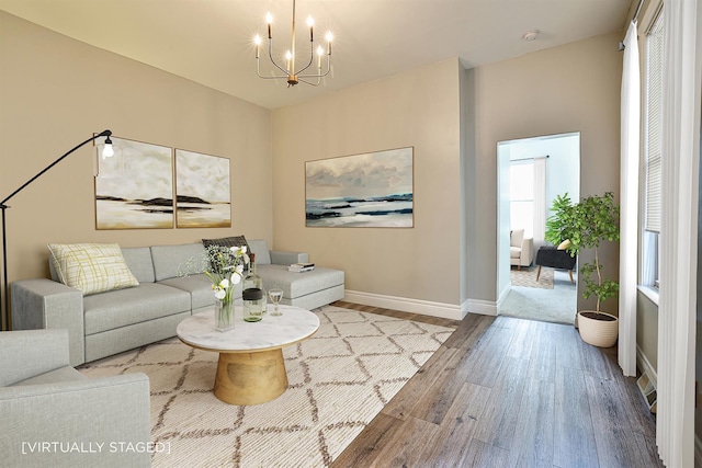 living room featuring light hardwood / wood-style floors and an inviting chandelier