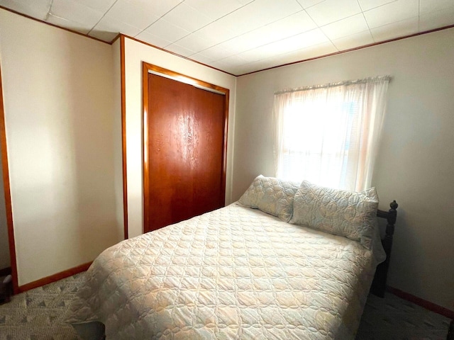 bedroom with carpet and a closet