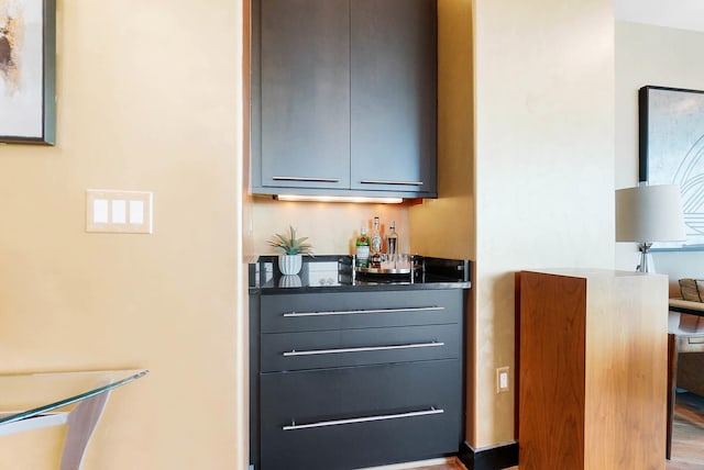 bar featuring hardwood / wood-style floors and gray cabinetry