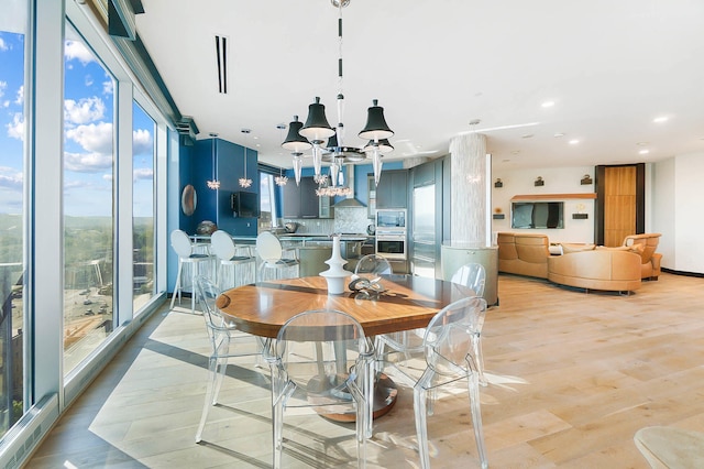 dining room featuring a notable chandelier and light wood-type flooring