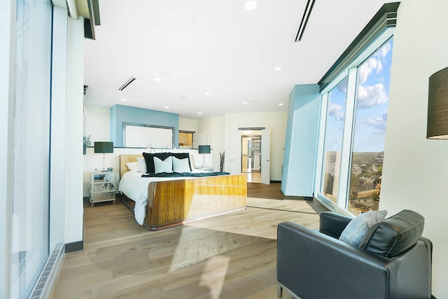 bedroom featuring light hardwood / wood-style flooring and multiple windows