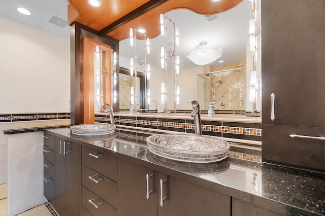 bathroom with vanity and a shower