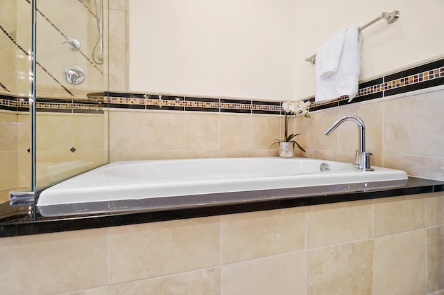 bathroom featuring tiled bath